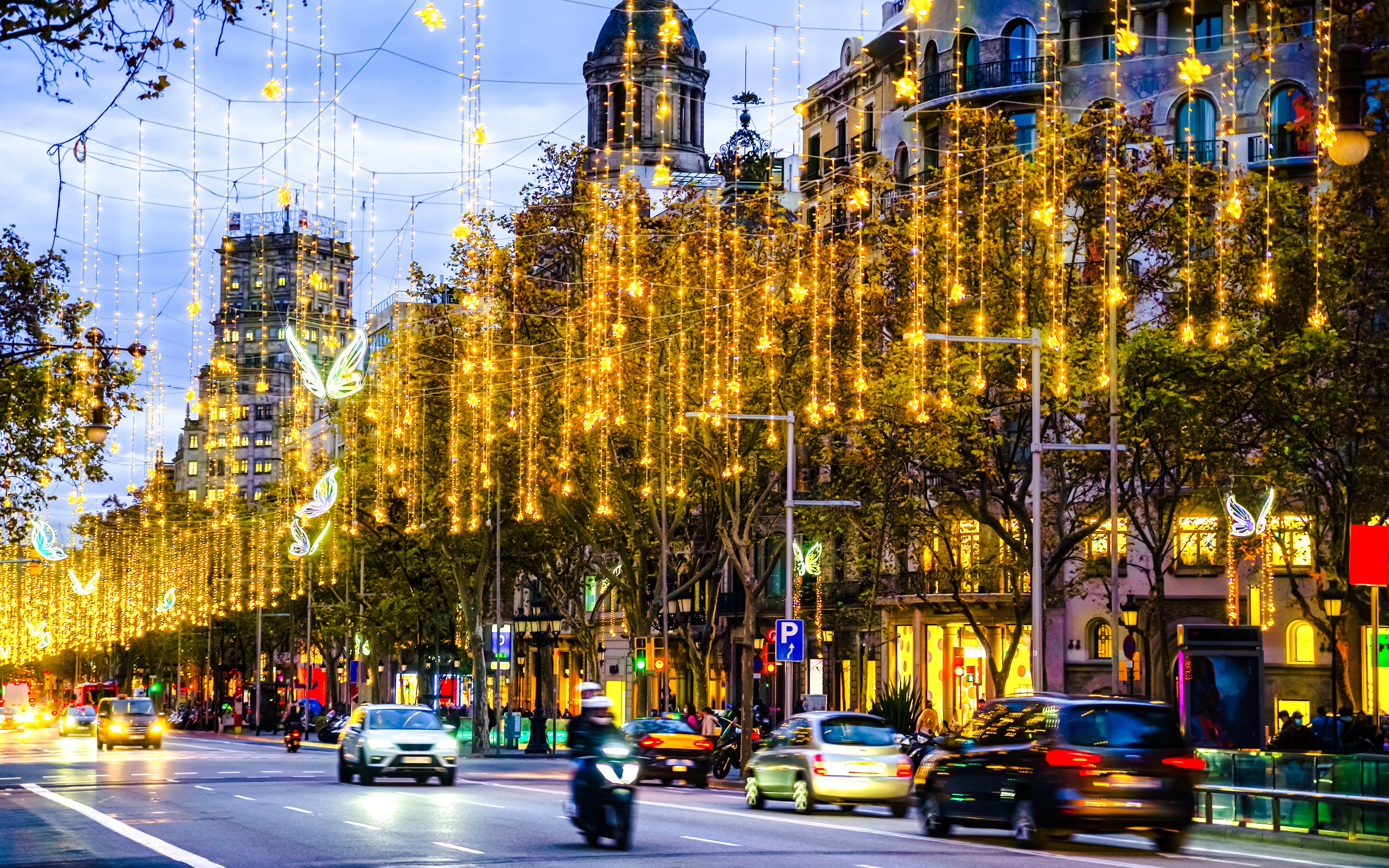 Barcelona street adorned with Christmas lights during a festive tour.
