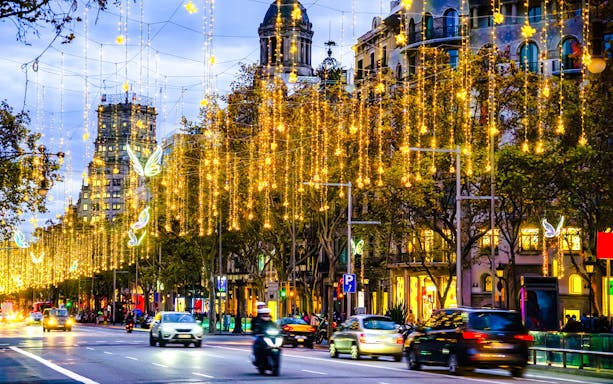 Barcelona street adorned with Christmas lights during a festive tour.