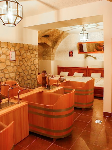 Wooden tubs and stone walls inside Bernard Beer Spa.