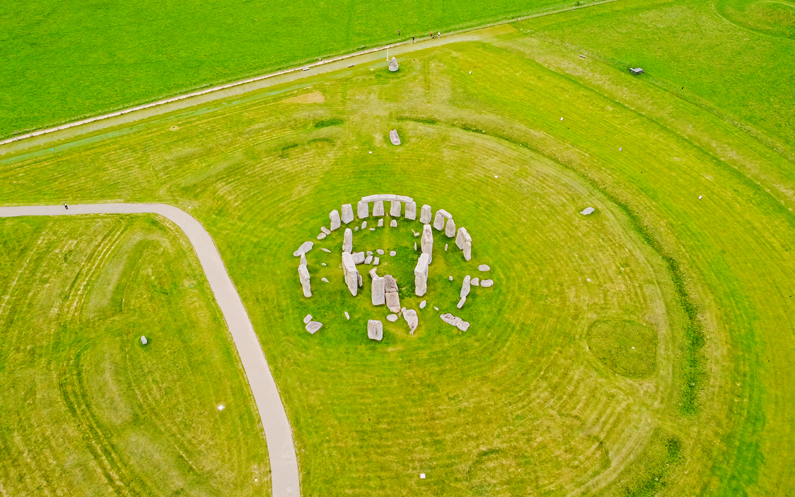 Aerial view of Stonehenge stone circle surrounded by green fields near London.