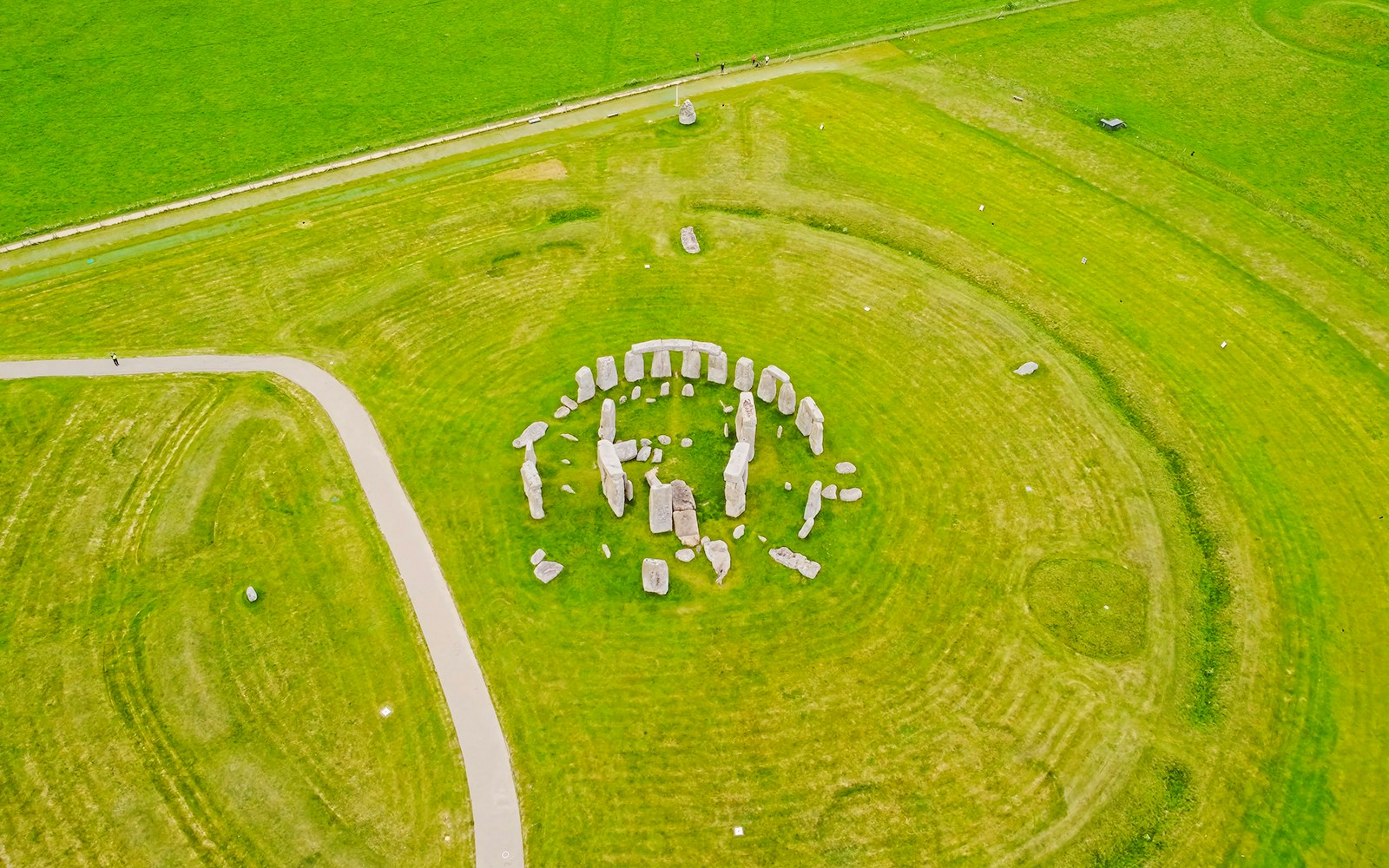 Aerial view of Stonehenge stone circle surrounded by green fields near London.