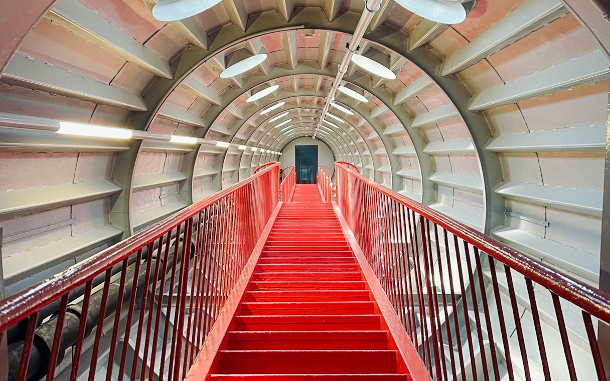 Red staircase inside the Atomium tunnel in Brussels.