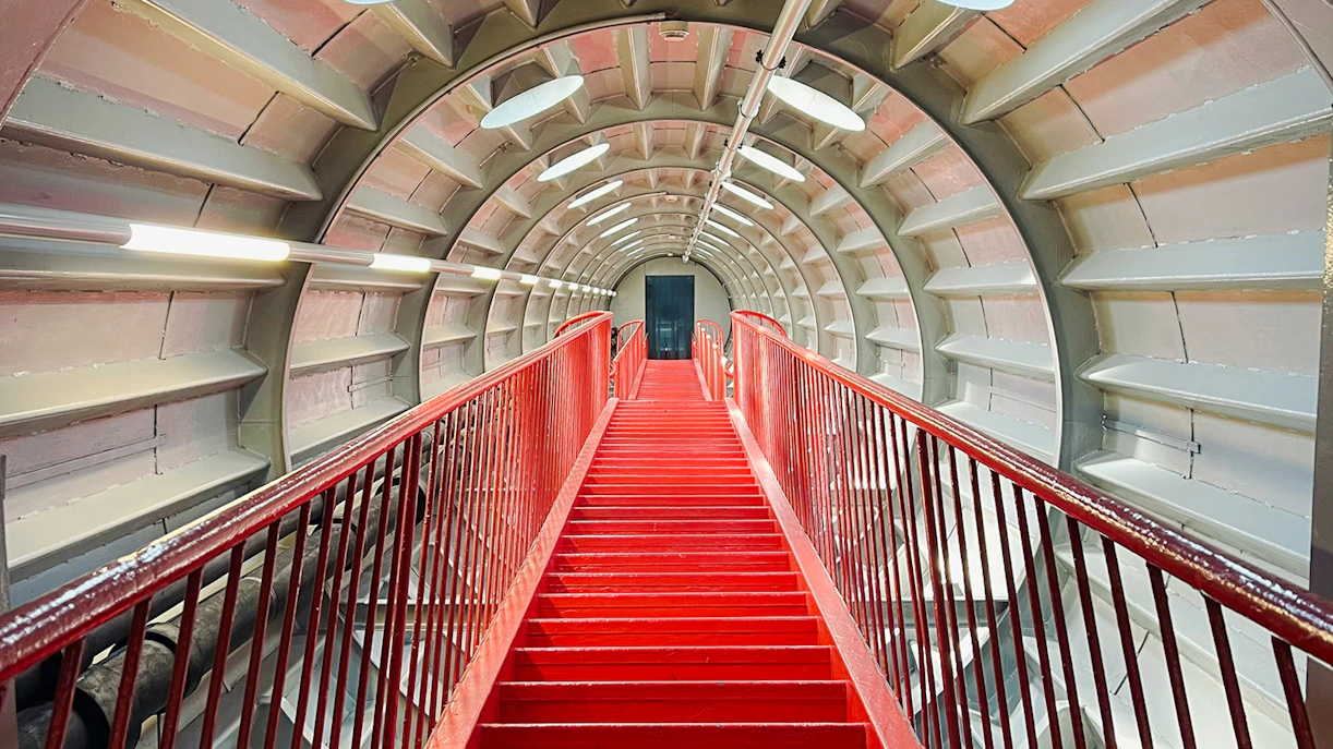 Red staircase inside the Atomium tunnel in Brussels.