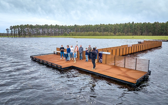 Group of people on a floating platform during Kooyang Yana full day tour, surrounded by water and trees.