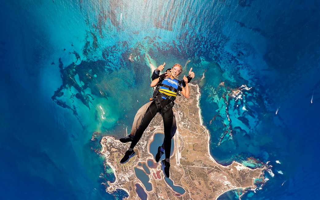 Tandem skydive over Rottnest Island, Perth, with aerial view of coastline and ocean.
