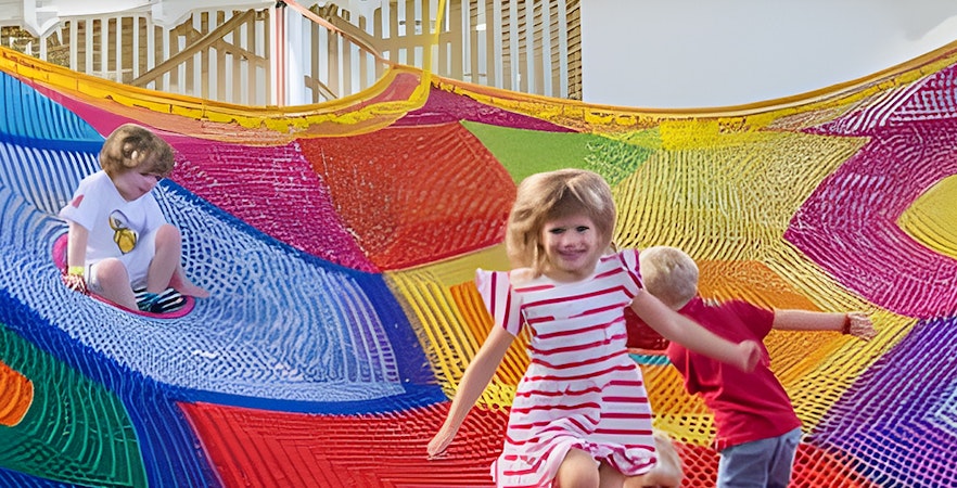 Children playing on colorful nets at Olioli Children's Play Museum, Dubai.
