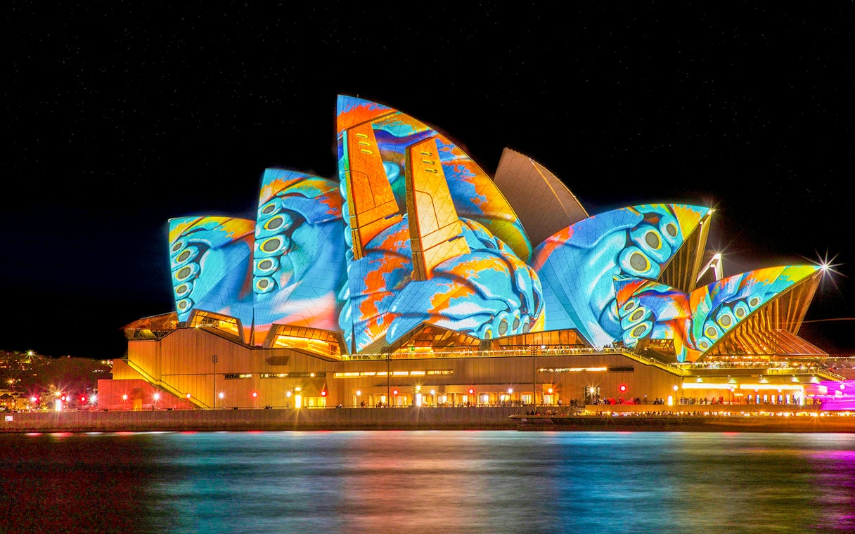 Sydney Opera House illuminated with vibrant Vivid Lights display.
