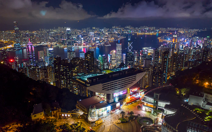 Skyline view of Hong Kong from Sky Terrace 428 at night, featuring illuminated skyscrapers and Victoria Harbour.