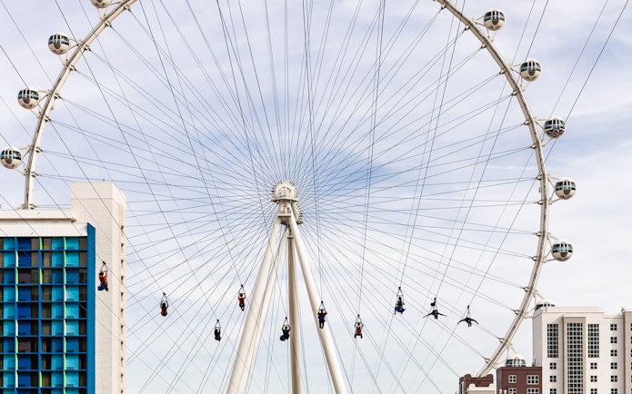 Las Vegas High Roller with zipliners in foreground, part of Go City Explorer attractions.