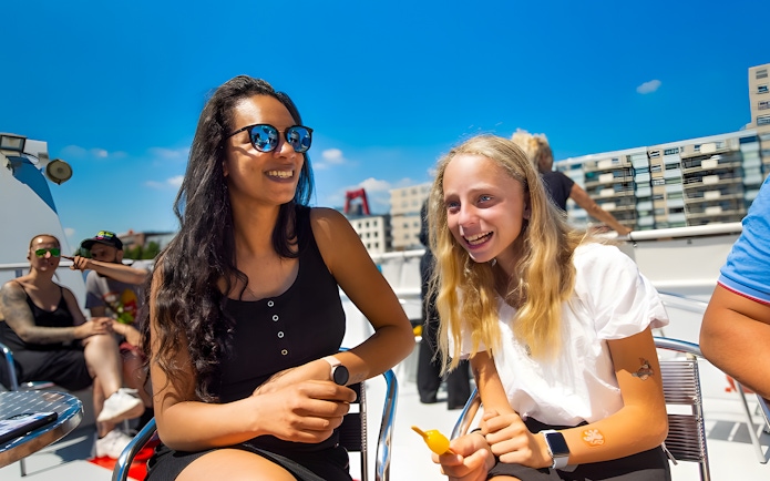 Guests enjoying a sunny day on a city cruise.