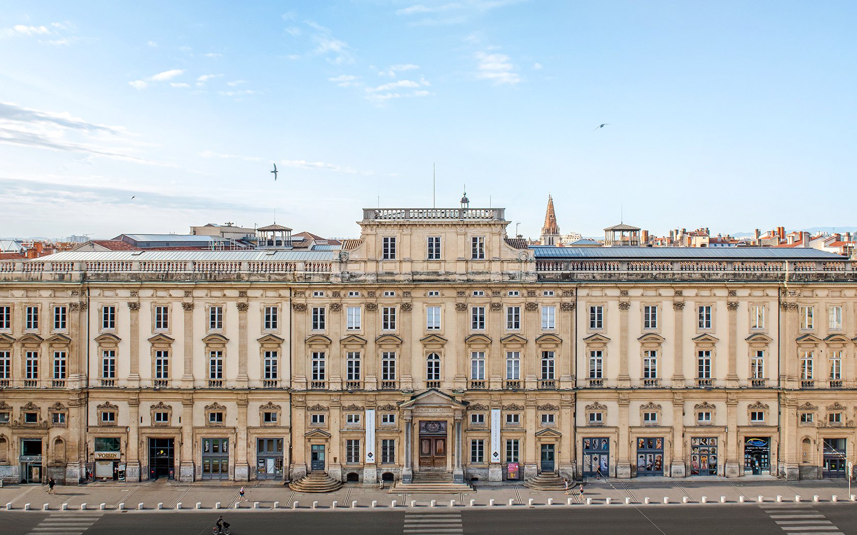 Museum of Fine Arts facade, Lyon, France, with clear sky and cityscape in background.