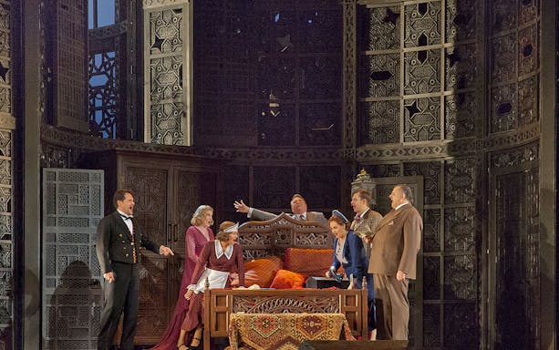 Opera performers on stage during Le Nozze Di Figaro, intricate set design in the background.