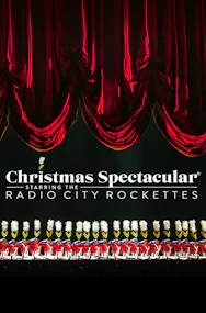 Radio City Rockettes performing in Christmas Spectacular under red curtains.
