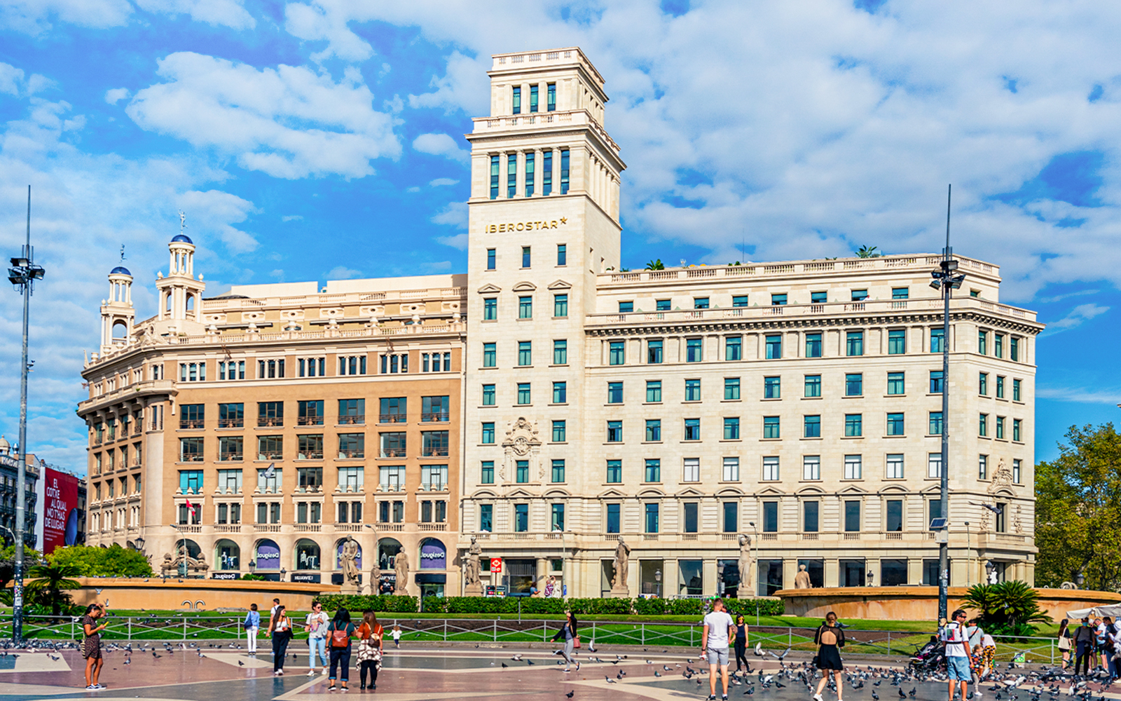 Plaça de Catalunya Barcelona bustling square with fountains and people.