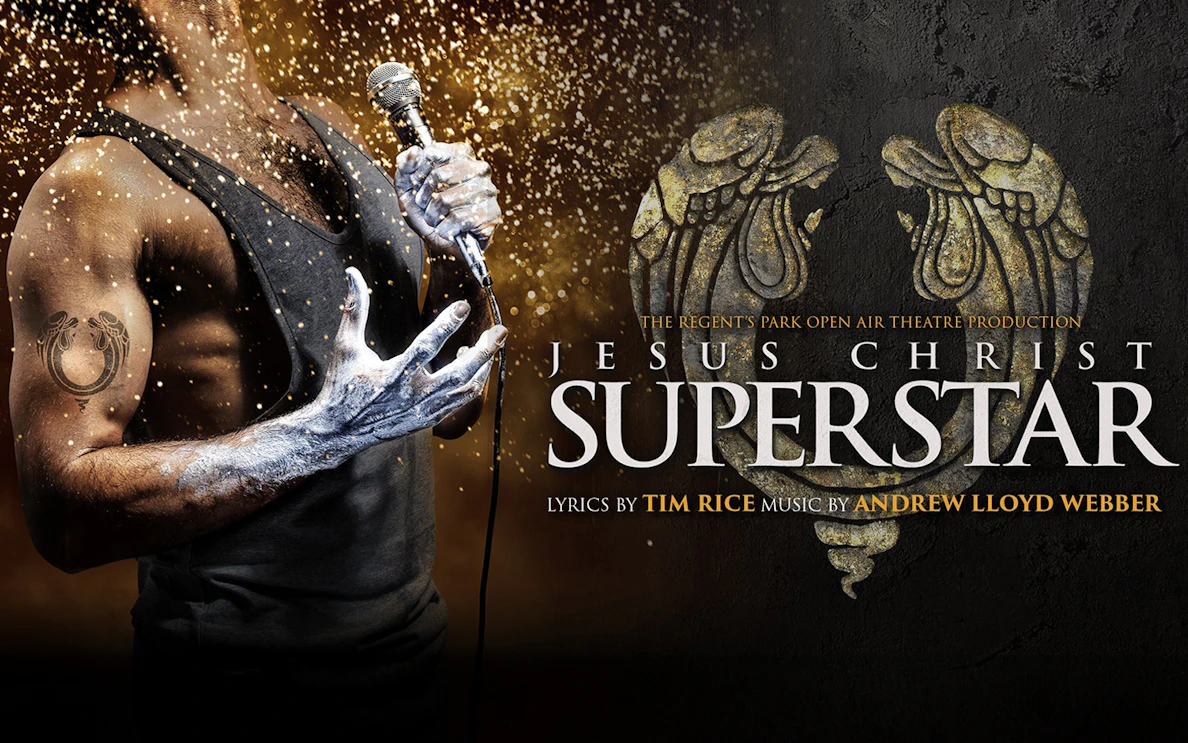 Performer holding a microphone with "Jesus Christ Superstar" text and decorative design.