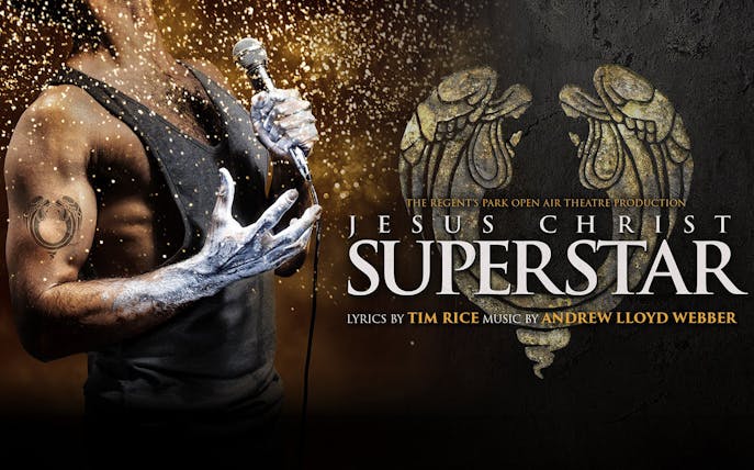 Performer holding a microphone with "Jesus Christ Superstar" text and decorative design.