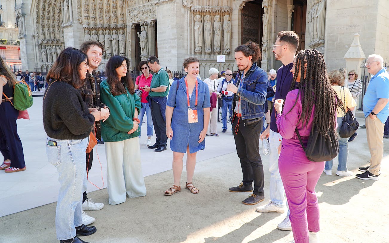 Guide talking with tourists in front of Notre Dame Cathedral, Paris.