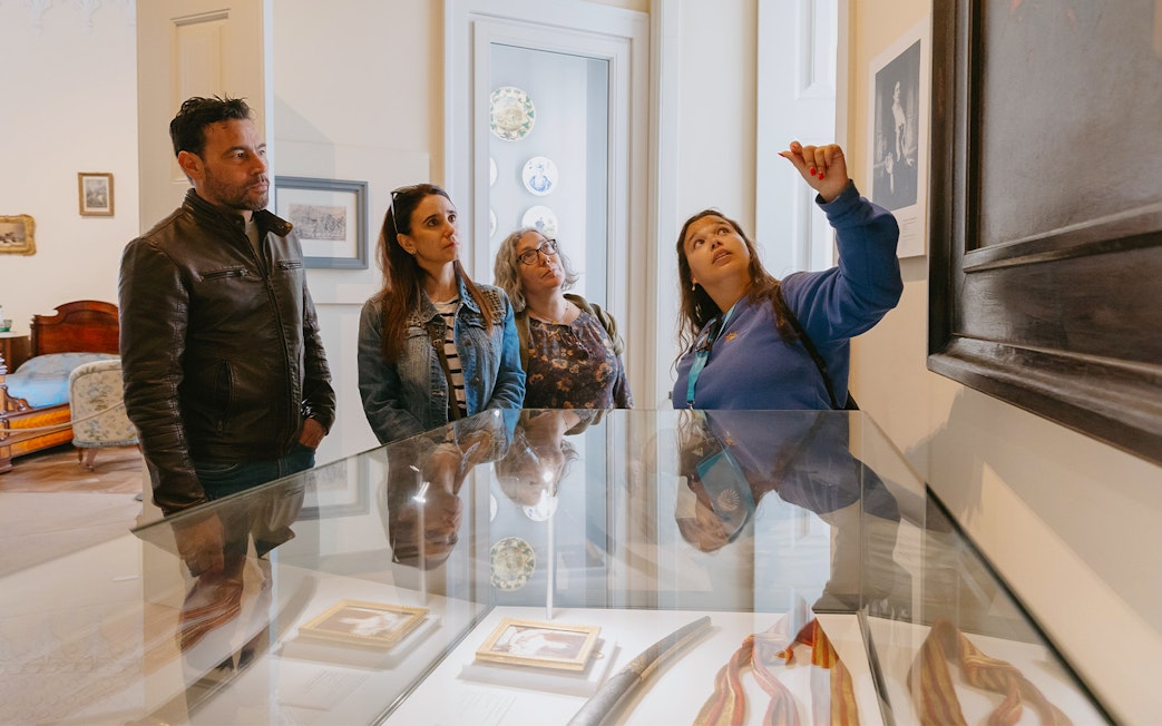 Tour group observing artwork during Pena Palace guided tour.
