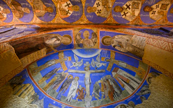 Frescos and murals depicting religious figures in ancient cave at Gerome Open Air Museum.