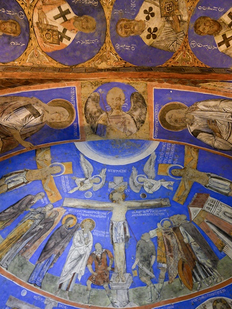 Frescos and murals depicting religious figures in ancient cave at Gerome Open Air Museum.