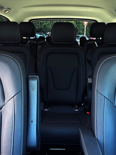 Mercedes E Class interior with black leather seats and spacious rear seating arrangement.