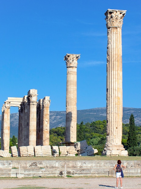Temple of Olympian Zeus ruins with tourists in Athens, Greece.