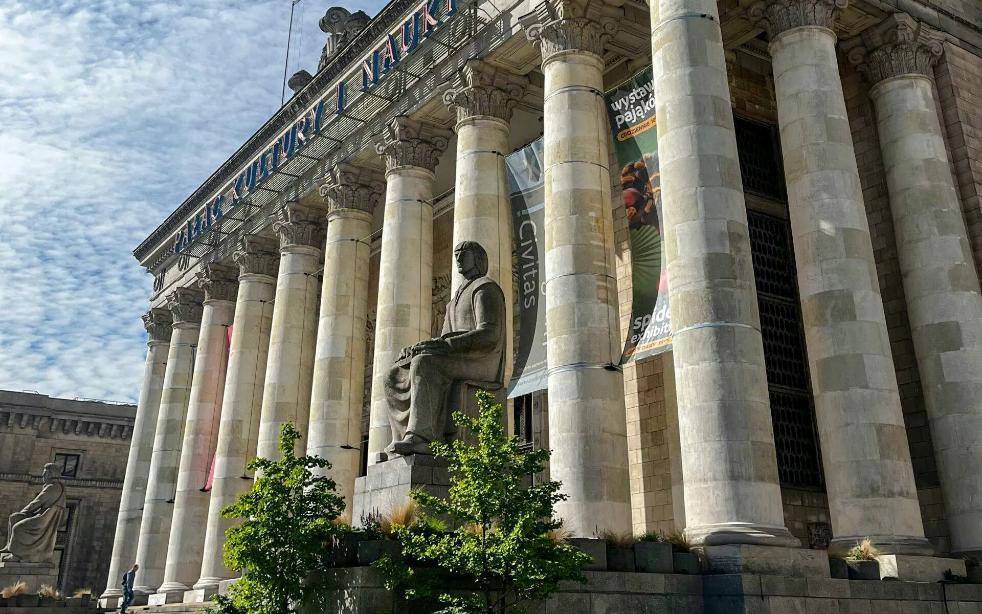 Palace of Culture and Science entrance with columns and statue in Warsaw.