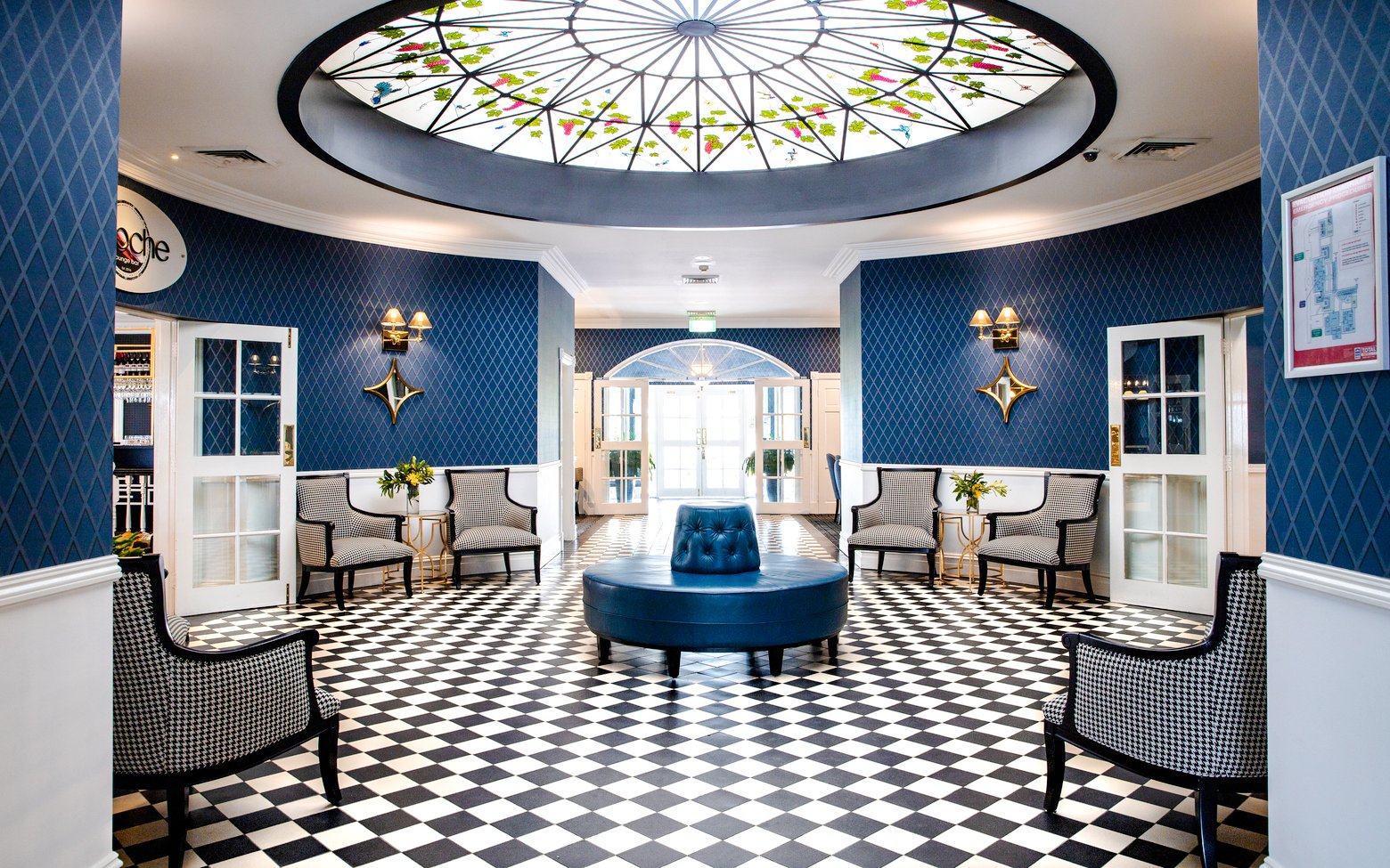 Elegant lounge area with checkered floor and stained glass ceiling in Hunter Valley tour venue.