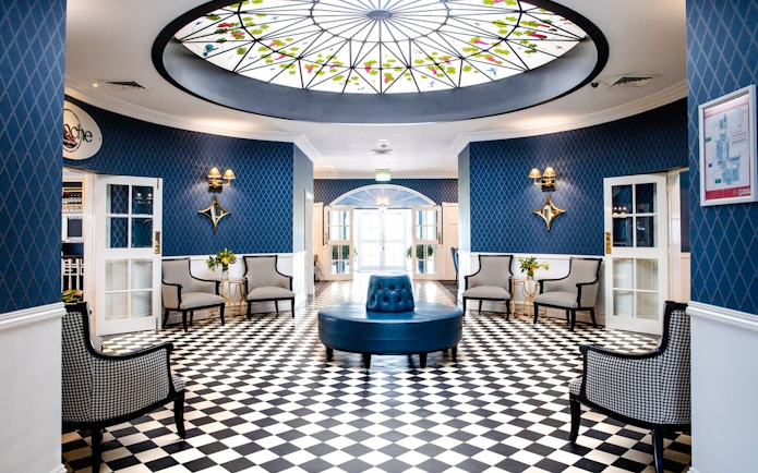 Elegant lounge area with checkered floor and stained glass ceiling in Hunter Valley tour venue.
