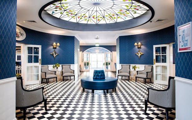 Elegant lounge area with checkered floor and stained glass ceiling in Hunter Valley tour venue.