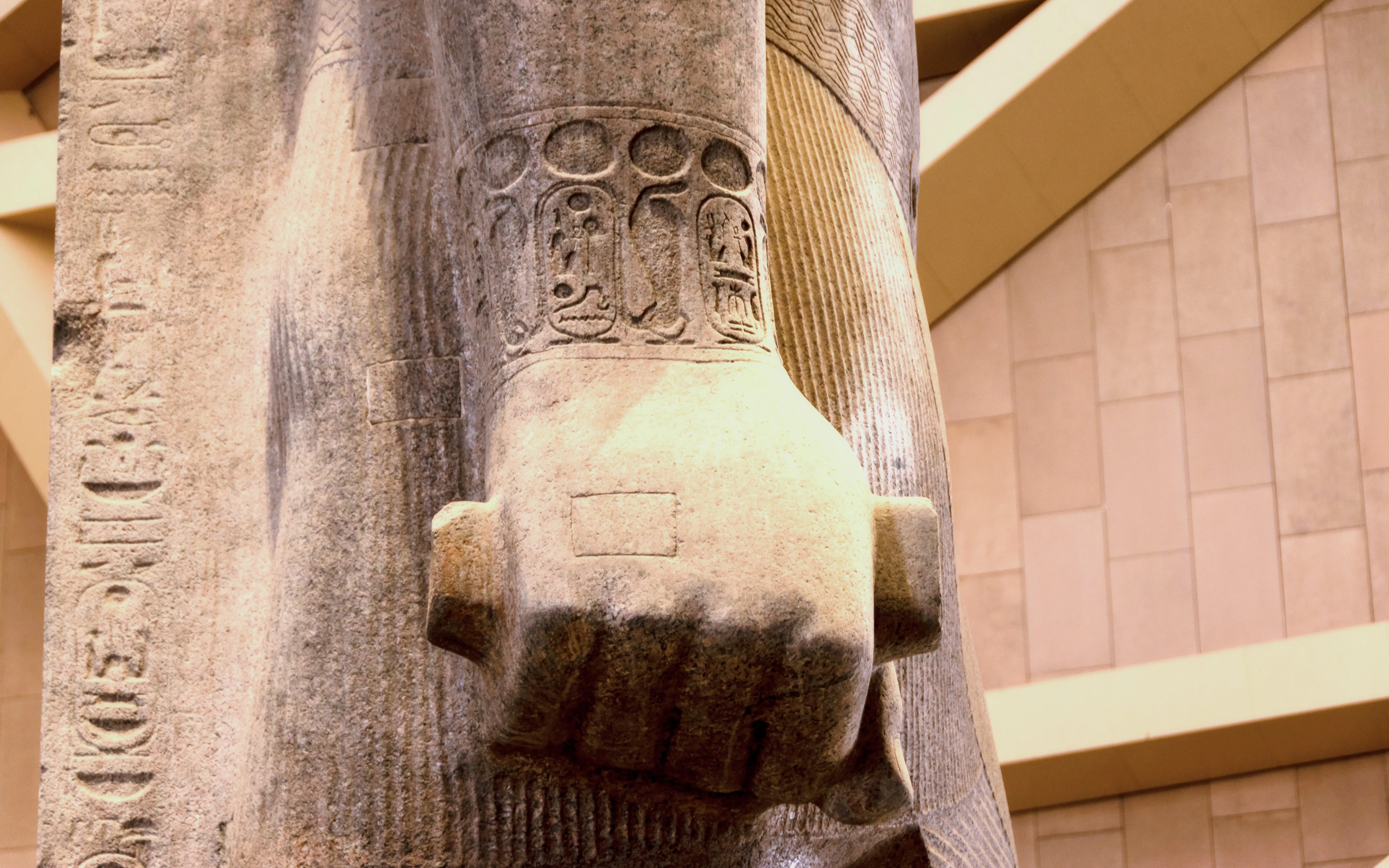 Colossal statue of Pharaoh Ramesses II's arm with hieroglyphs, Grand Egyptian Museum.