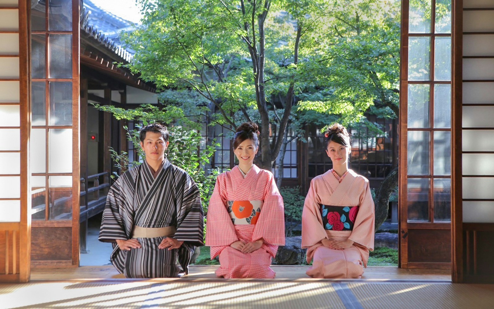 People in kimonos sitting in a traditional room at Kiyomizu Temple, Kyoto.
