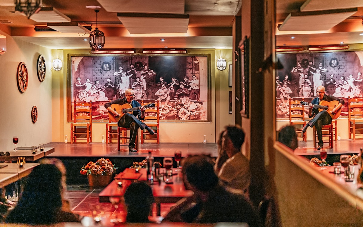 Guitarist performing at La Cantaora Flamenco show in Seville, Spain.