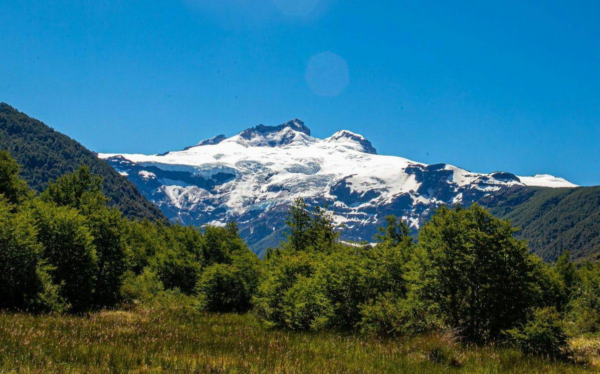 Mount Tronador with snow-capped peaks and lush valleys in Nahuel Huapi National Park.