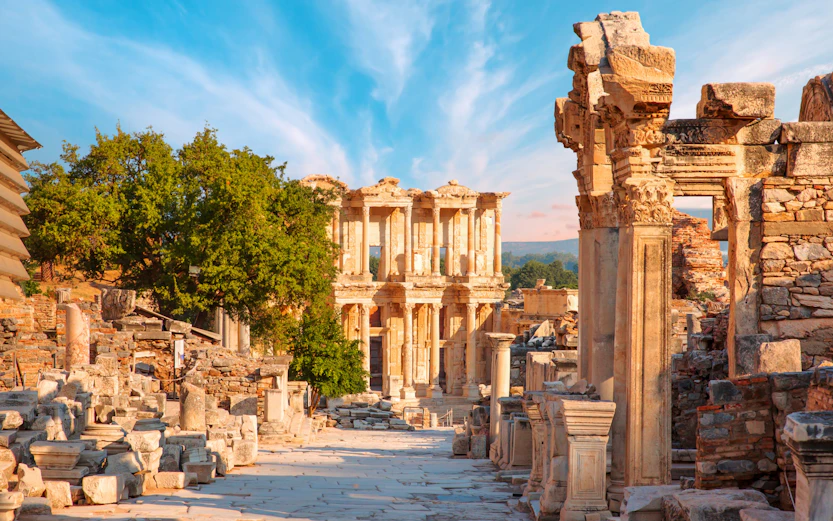 Celsus Library ruins in Ephesus, Turkey, with ancient stone columns and blue sky.