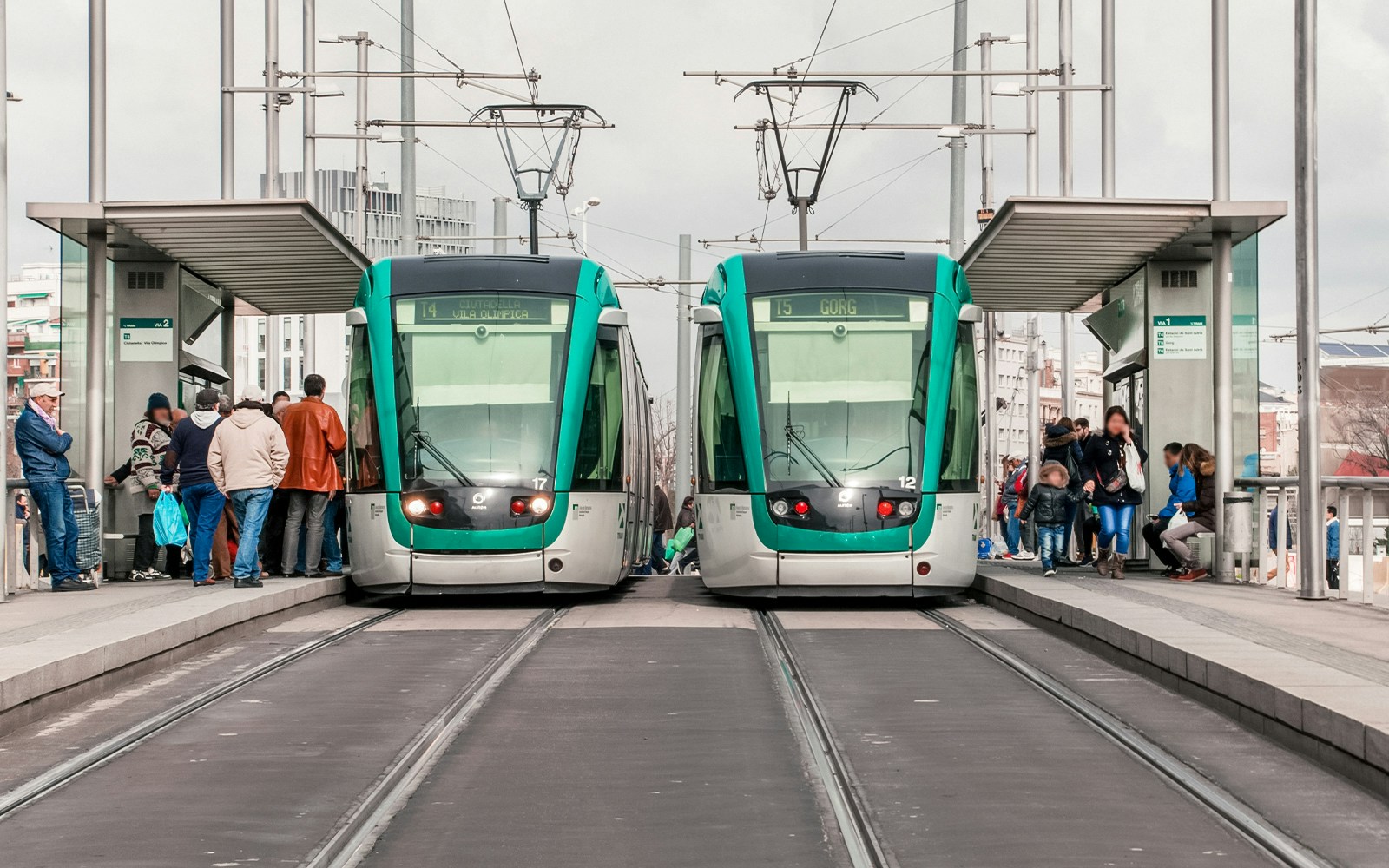 Tourists enjoying a scenic ride on the Barcelona tram with a beautiful city view in the background