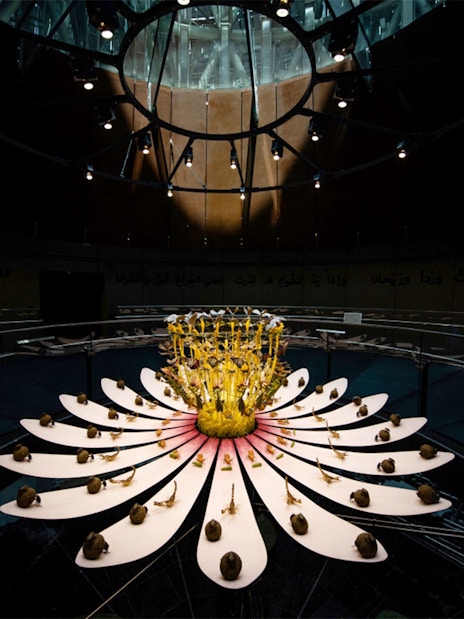 Expo City Dubai installation with illuminated flower sculpture under a glass dome.