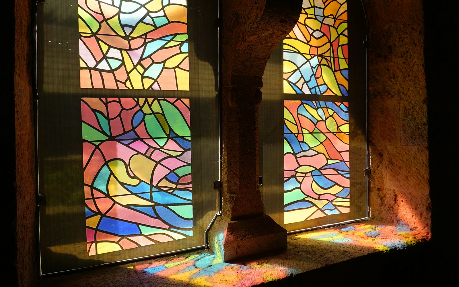 Sunlight streaming through stained glass windows at Sainte-Chapelle, Paris.