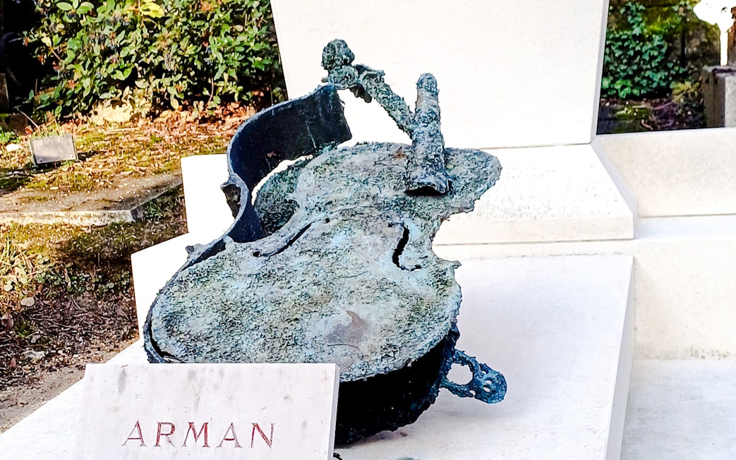 Sculpture of a broken cello by Arman in Père Lachaise Cemetery, France.