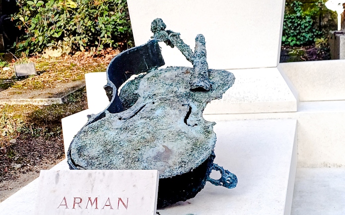 Sculpture of a broken cello by Arman in Père Lachaise Cemetery, France.