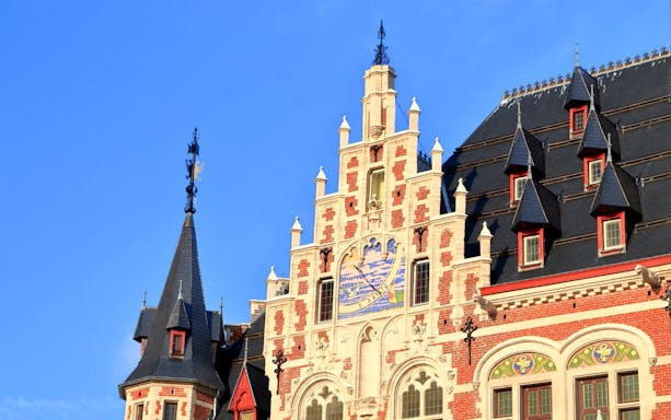 Gothic-style building facade in Brussels with ornate gables and decorative elements.
