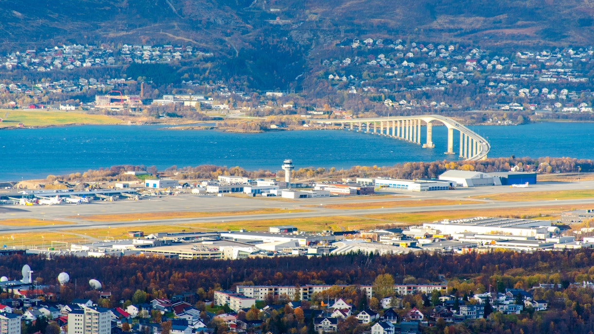 Tromso Airport with runway and control tower, bridge over water, Norway.