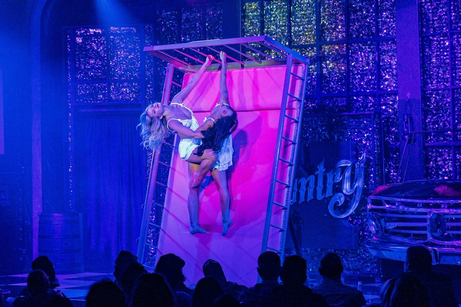 Performers on stage during Kick'n Topless Revue in Vegas, featuring acrobatic dance.
