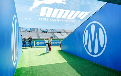 Visitors exploring OM Stadium entrance during a tour in Marseille.
