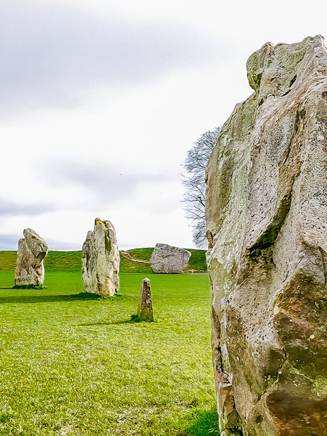 Avebury stone circle in a green field, part of a full-day tour from London.