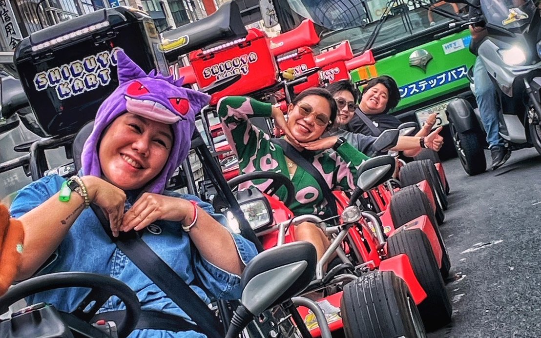 Go-kart riders in costume enjoying Shibuya Kart tour through Tokyo streets.