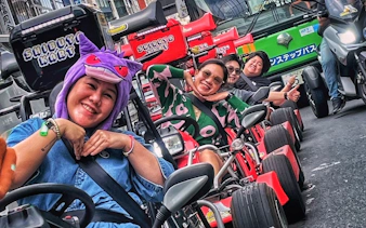 Go-kart riders in costume enjoying Shibuya Kart tour through Tokyo streets.