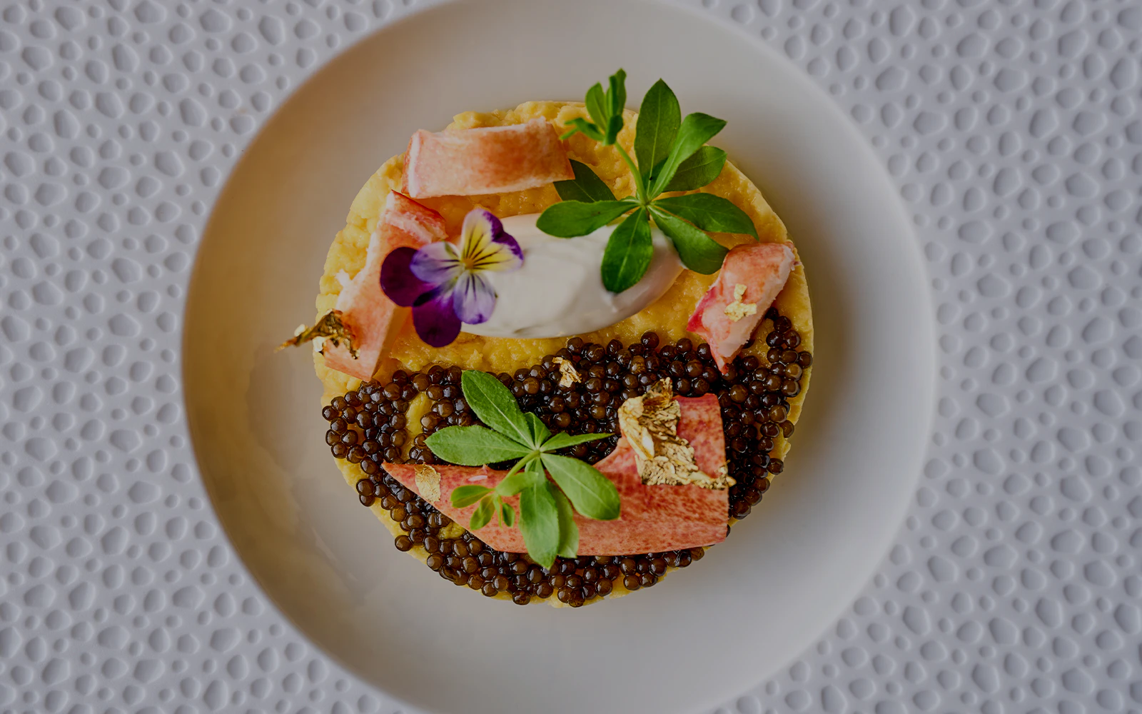 Gourmet dish with caviar and edible flowers at At.Mosphere, Burj Khalifa, Dubai.