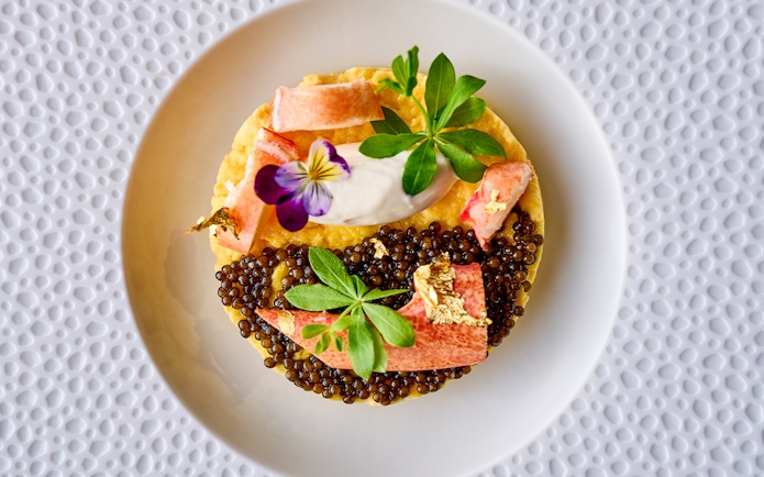 Gourmet dish with caviar and edible flowers at At.Mosphere, Burj Khalifa, Dubai.