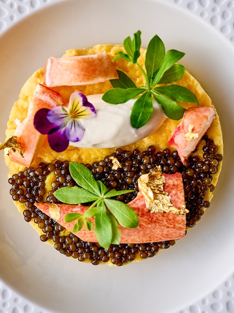 Gourmet dish with caviar and edible flowers at At.Mosphere, Burj Khalifa, Dubai.